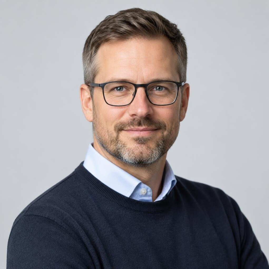 Studio portrait of a German man researcher with glasses